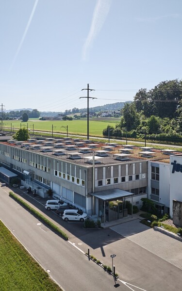 Aerial view of the Jossi company headquarters featuring production and office facilities in a rural setting. The image showcases the company’s location and the modern infrastructure of the industrial automation specialist.